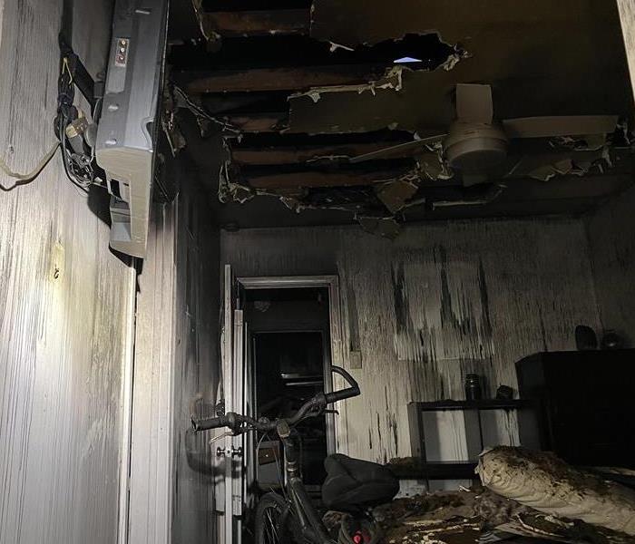 SERVPRO performing fire damage restoration in a residential home.